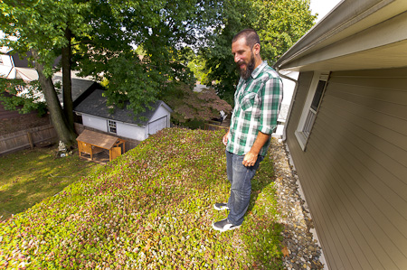 Scott Harris standing on the green roof covering the back of his house Scott Harris standing on the green roof covering the back of his house